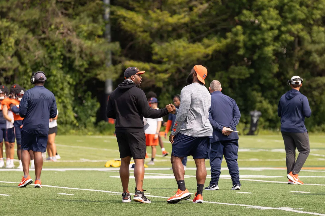 Fran Brown running onto the JMA Dome field with Syracuse Football players.