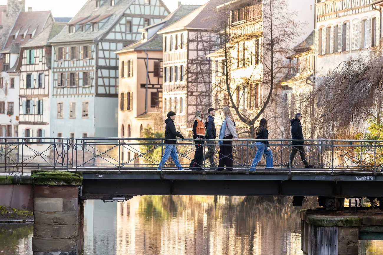 Students walking across a bridge in Strasbourg, France.