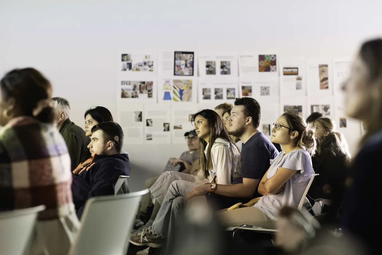 Students sitting in a classroom learning.